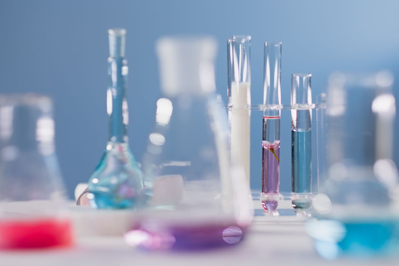 journey Close-up of various glassware with colorful liquids in a lab setting.