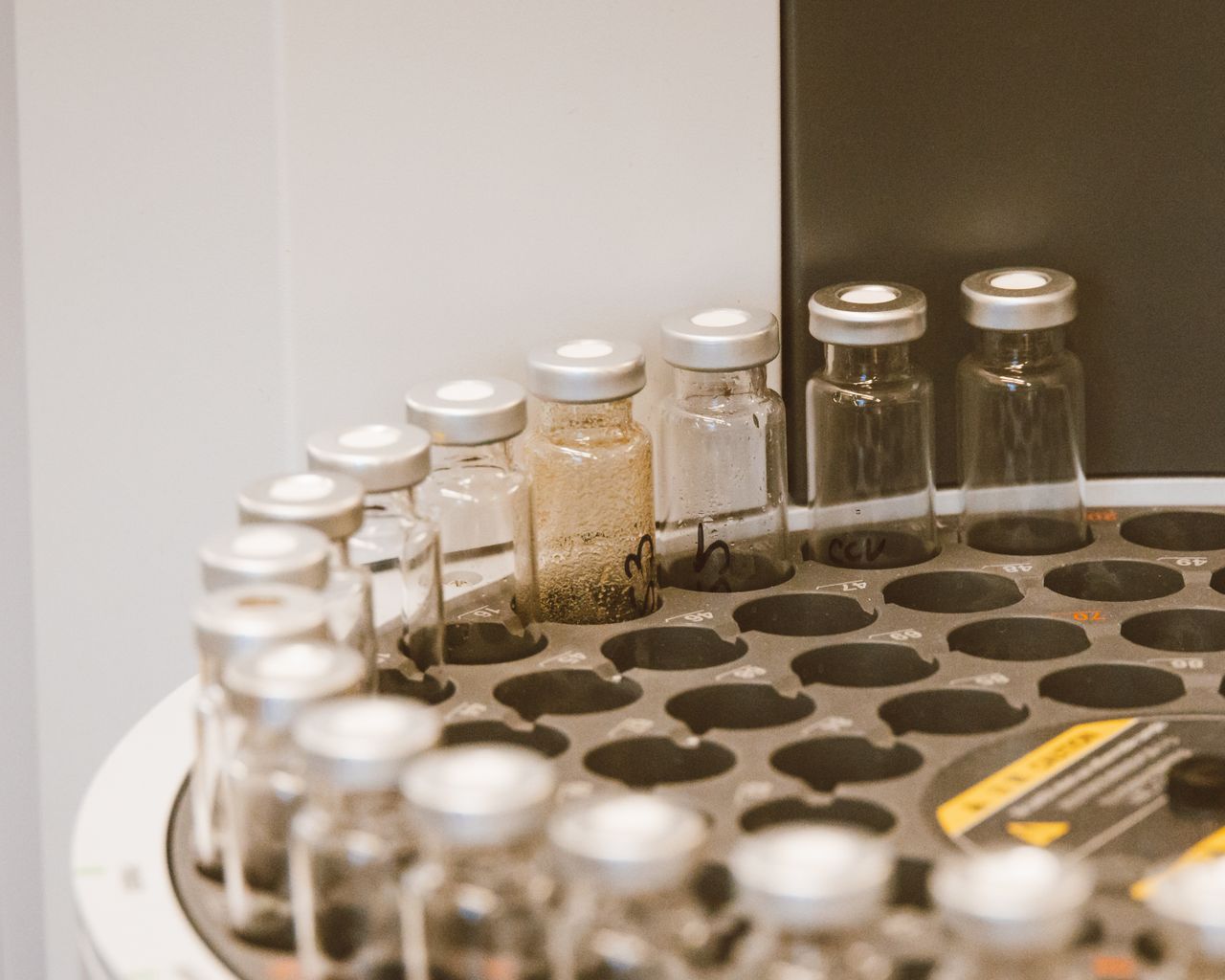 category-01 Vials arranged in a lab rack, showcasing scientific organization and research preparation.